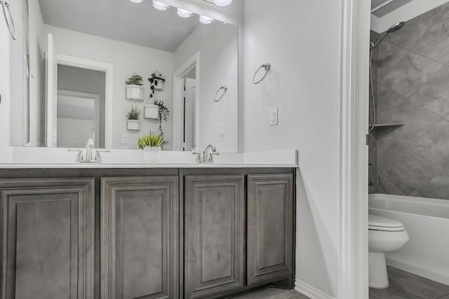 full bathroom featuring vanity, toilet, and tiled shower / bath combo