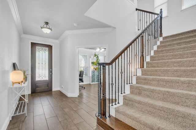 entryway featuring hardwood / wood-style flooring and ornamental molding