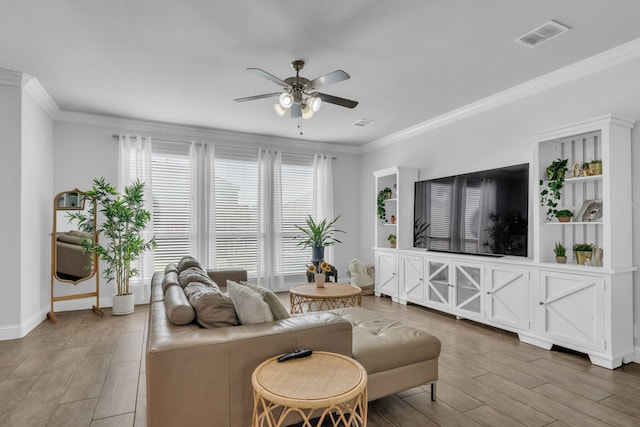 living room with hardwood / wood-style floors, ceiling fan, and ornamental molding