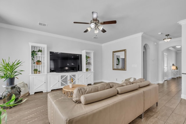 living room with ceiling fan and ornamental molding