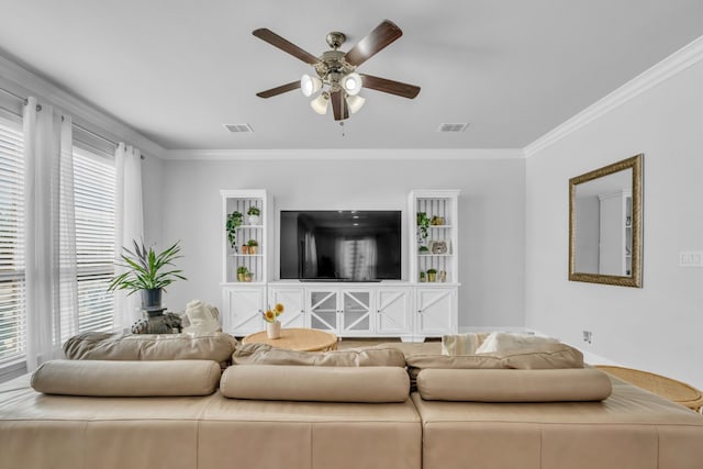 living room with ceiling fan and ornamental molding