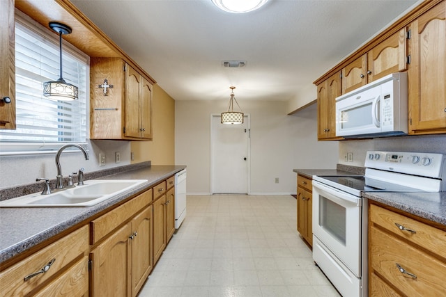 kitchen featuring decorative light fixtures, white appliances, and sink