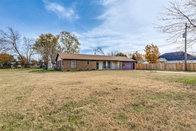 view of front of house with a garage and a front lawn