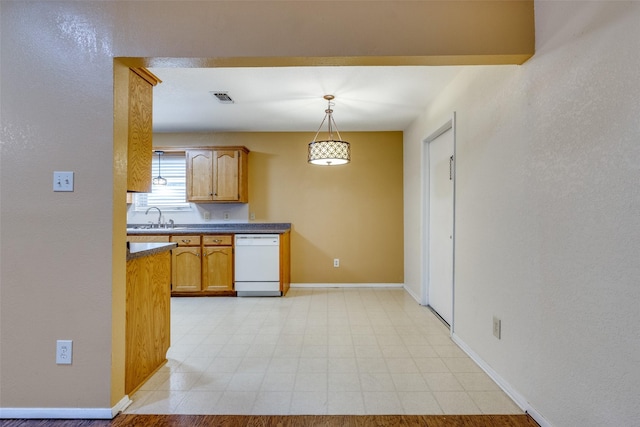 kitchen with hanging light fixtures, sink, and dishwasher