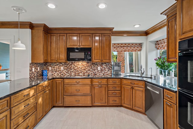 kitchen featuring dark stone countertops, black appliances, crown molding, decorative light fixtures, and sink