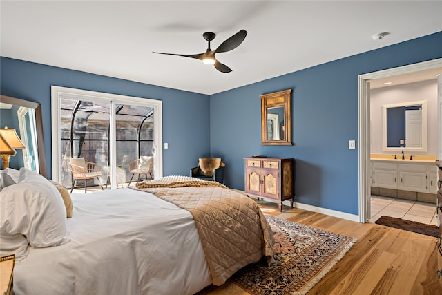 bedroom with light hardwood / wood-style floors, sink, and ceiling fan