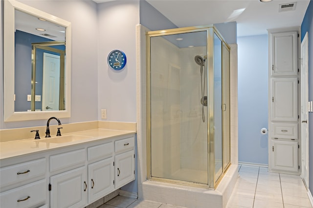 bathroom with vanity, an enclosed shower, and tile patterned floors