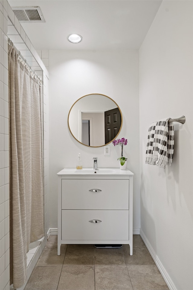 bathroom featuring vanity and a shower with shower curtain