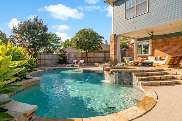 view of swimming pool featuring a patio, ceiling fan, and pool water feature