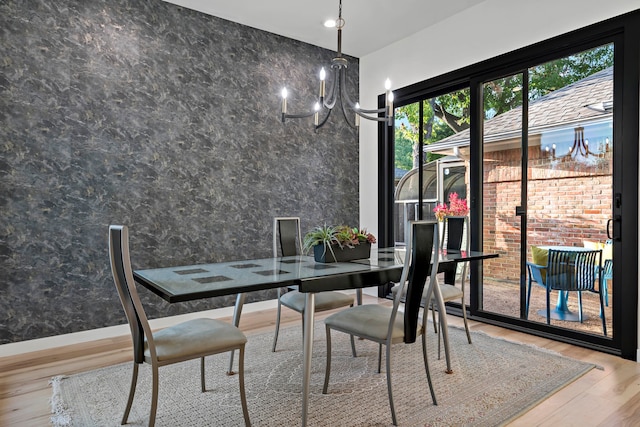 dining area featuring an inviting chandelier and hardwood / wood-style flooring