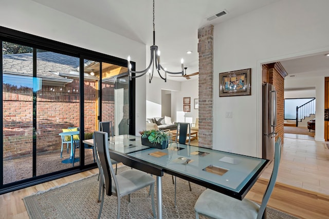 dining area featuring hardwood / wood-style flooring and a chandelier