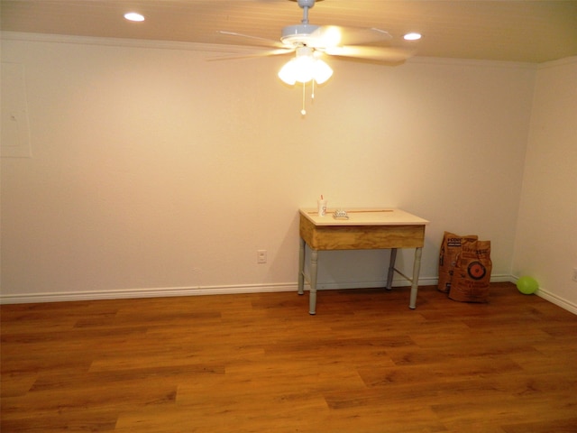 spare room featuring ceiling fan, wood-type flooring, and ornamental molding