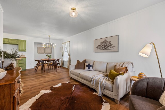 unfurnished dining area with crown molding, plenty of natural light, wood-type flooring, and a notable chandelier