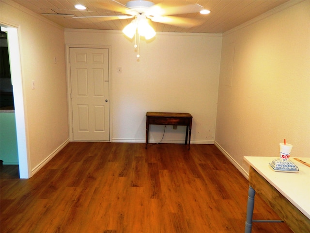 spare room featuring dark hardwood / wood-style floors, ceiling fan, and ornamental molding