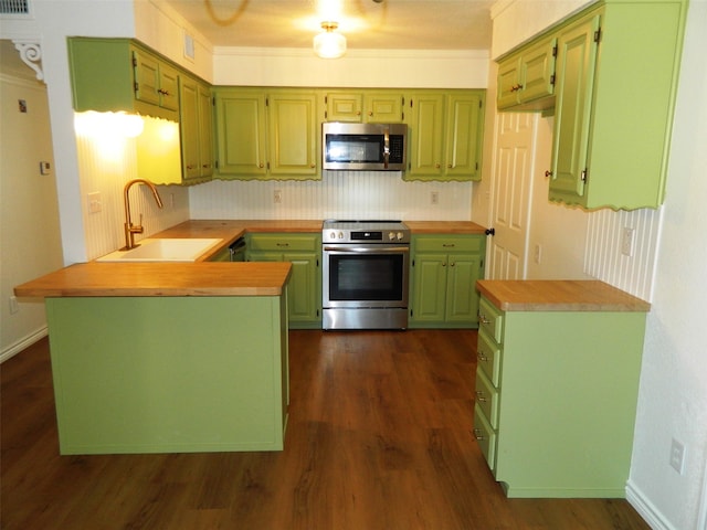 kitchen featuring wood counters, sink, dark hardwood / wood-style floors, appliances with stainless steel finishes, and kitchen peninsula