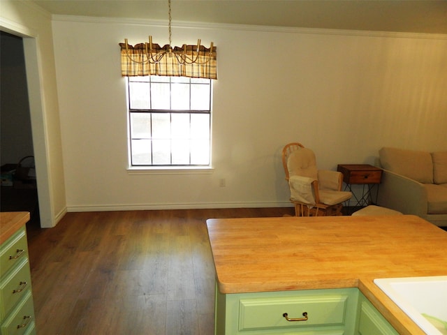 kitchen with wooden counters, dark wood-type flooring, a chandelier, hanging light fixtures, and green cabinets