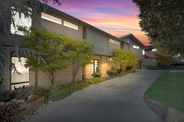 view of front of property featuring a garage and a yard