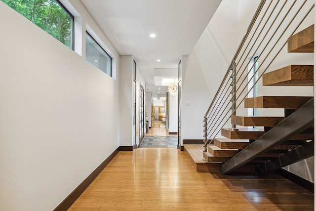 bedroom with light wood-type flooring, lofted ceiling, and ceiling fan