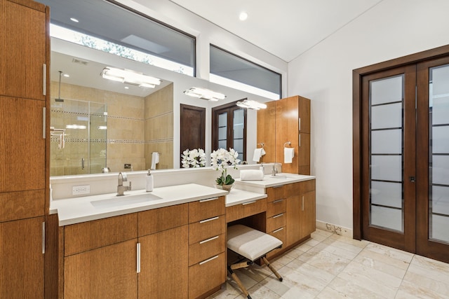 bathroom featuring french doors, an enclosed shower, and vanity