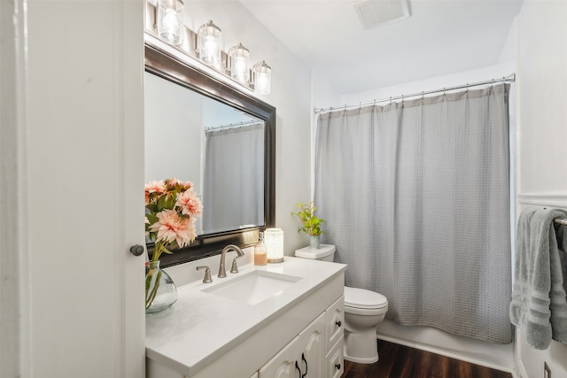 full bathroom featuring vanity, toilet, wood-type flooring, and shower / tub combo