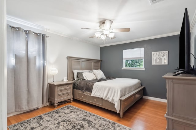 bedroom featuring ornamental molding, light hardwood / wood-style flooring, and ceiling fan