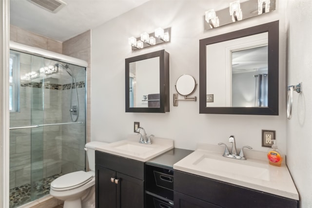 bathroom featuring vanity, toilet, and walk in shower