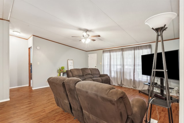 living room featuring ornamental molding, hardwood / wood-style flooring, and ceiling fan