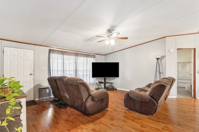 living room featuring ornamental molding, wood-type flooring, and ceiling fan