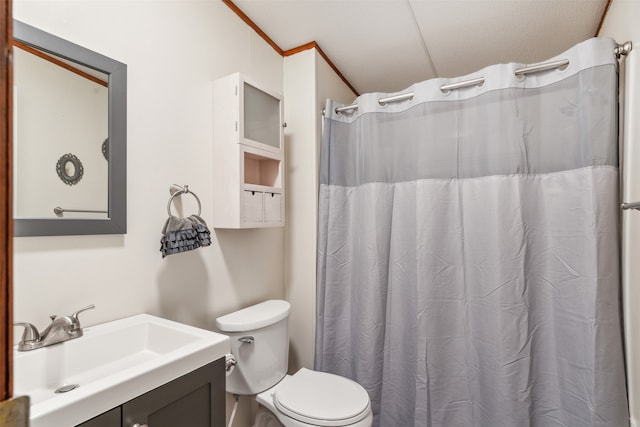 bathroom with vanity, crown molding, a shower with curtain, and toilet