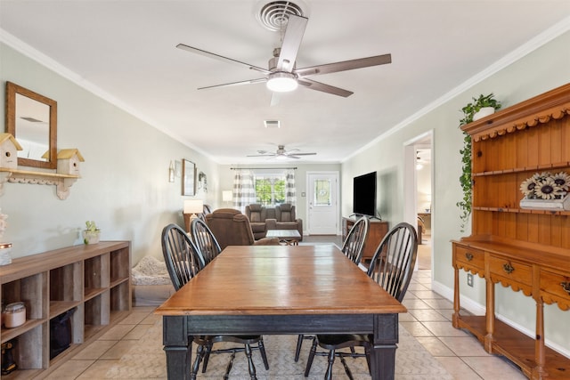 dining space featuring ornamental molding, ceiling fan, and light tile patterned floors