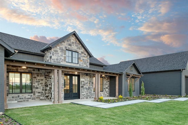 view of front of property featuring a patio and a lawn