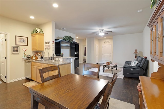 dining area with dark wood-type flooring, ceiling fan, and sink