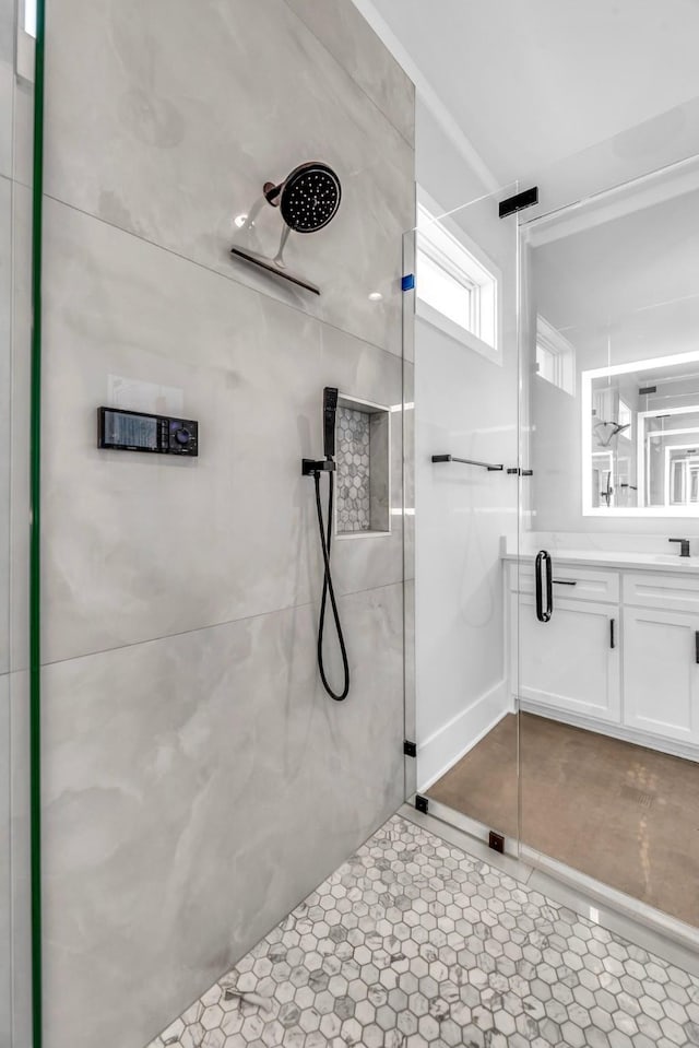 bathroom featuring sink, a shower with door, and tile patterned flooring