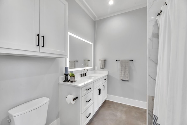 bathroom with vanity, toilet, and ornamental molding