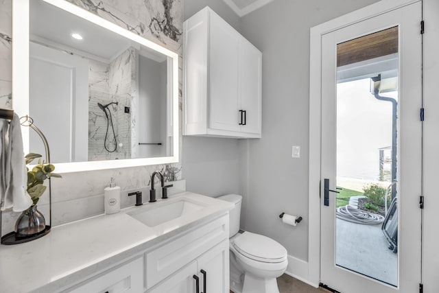 bathroom featuring plenty of natural light, toilet, a shower, and vanity