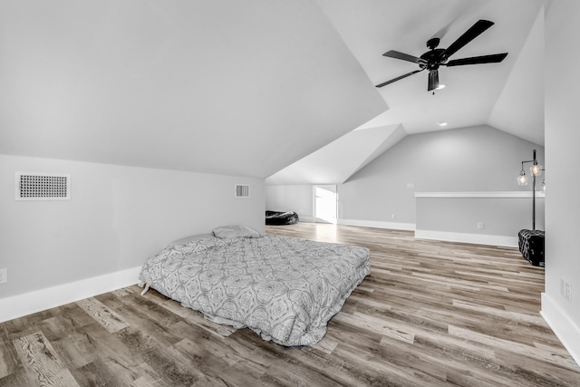 bedroom featuring light hardwood / wood-style floors, vaulted ceiling, and ceiling fan