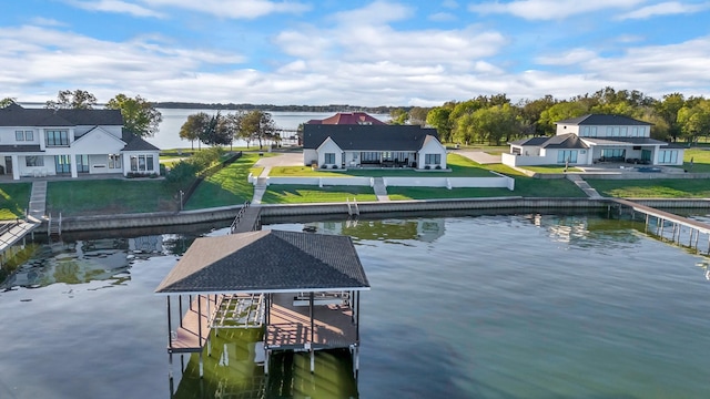 dock area with a water view and a yard