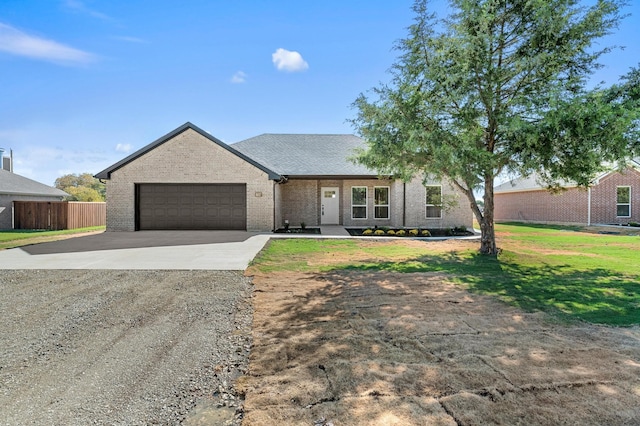 view of front of house with a garage and a front lawn