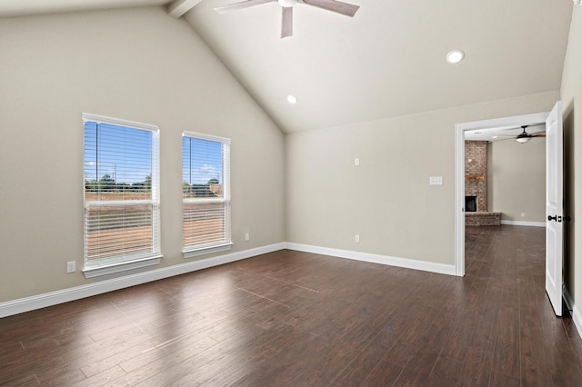 empty room featuring beam ceiling, a fireplace, high vaulted ceiling, and dark hardwood / wood-style flooring