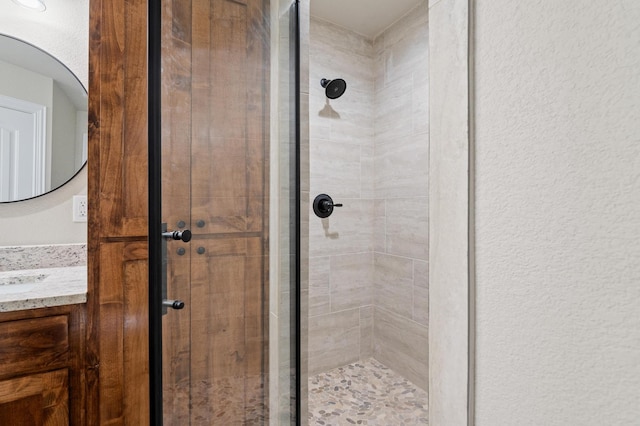 bathroom featuring vanity and an enclosed shower