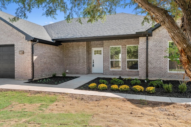 view of exterior entry with a garage