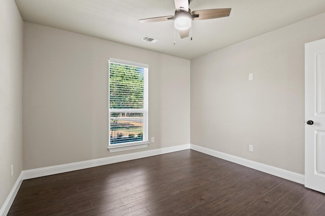 spare room featuring dark wood-type flooring and ceiling fan