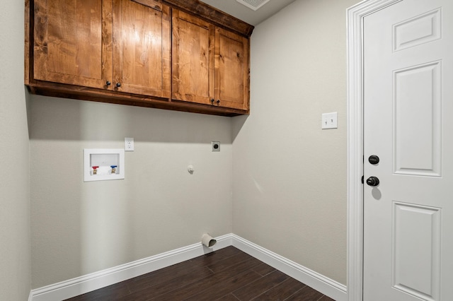 laundry room featuring cabinets, washer hookup, dark hardwood / wood-style floors, electric dryer hookup, and hookup for a gas dryer