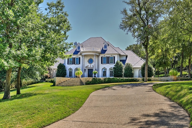 5804 Indianwood Ln, Fort Worth, TX 76132 - french country style house with driveway, a front lawn, and stucco siding