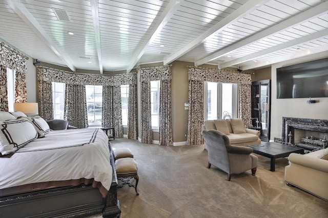 5804 Indianwood Ln, Fort Worth, TX 76132 - bedroom featuring multiple windows, beam ceiling, a fireplace, and carpet floors