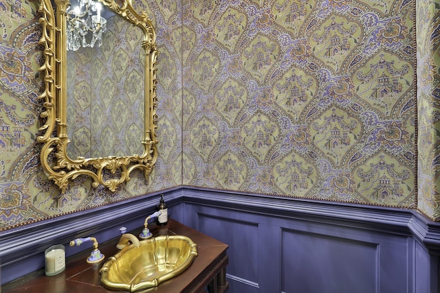 5804 Indianwood Ln, Fort Worth, TX 76132 - bathroom featuring wainscoting, a decorative wall, and vanity