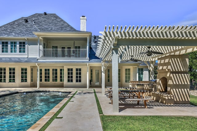 5804 Indianwood Ln, Fort Worth, TX 76132 - rear view of property featuring a pergola, a patio area, a balcony, a chimney, and an outdoor pool