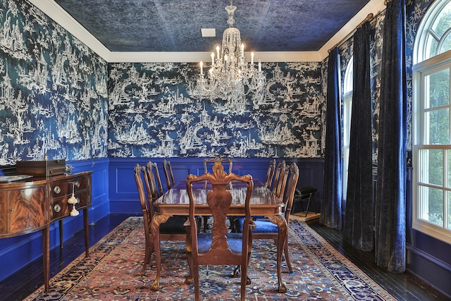 5804 Indianwood Ln, Fort Worth, TX 76132 - dining room featuring wainscoting, an inviting chandelier, wallpapered walls, wood finished floors, and crown molding