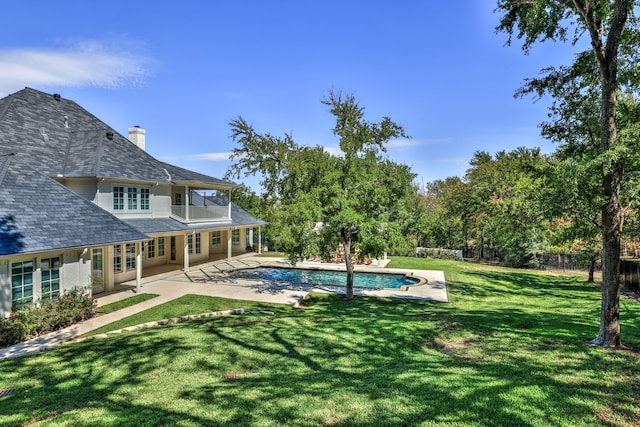 view of pool featuring a yard and a patio area