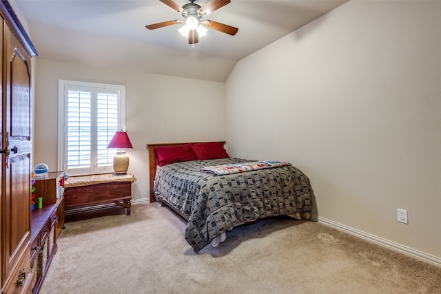 bedroom featuring vaulted ceiling, light carpet, and ceiling fan